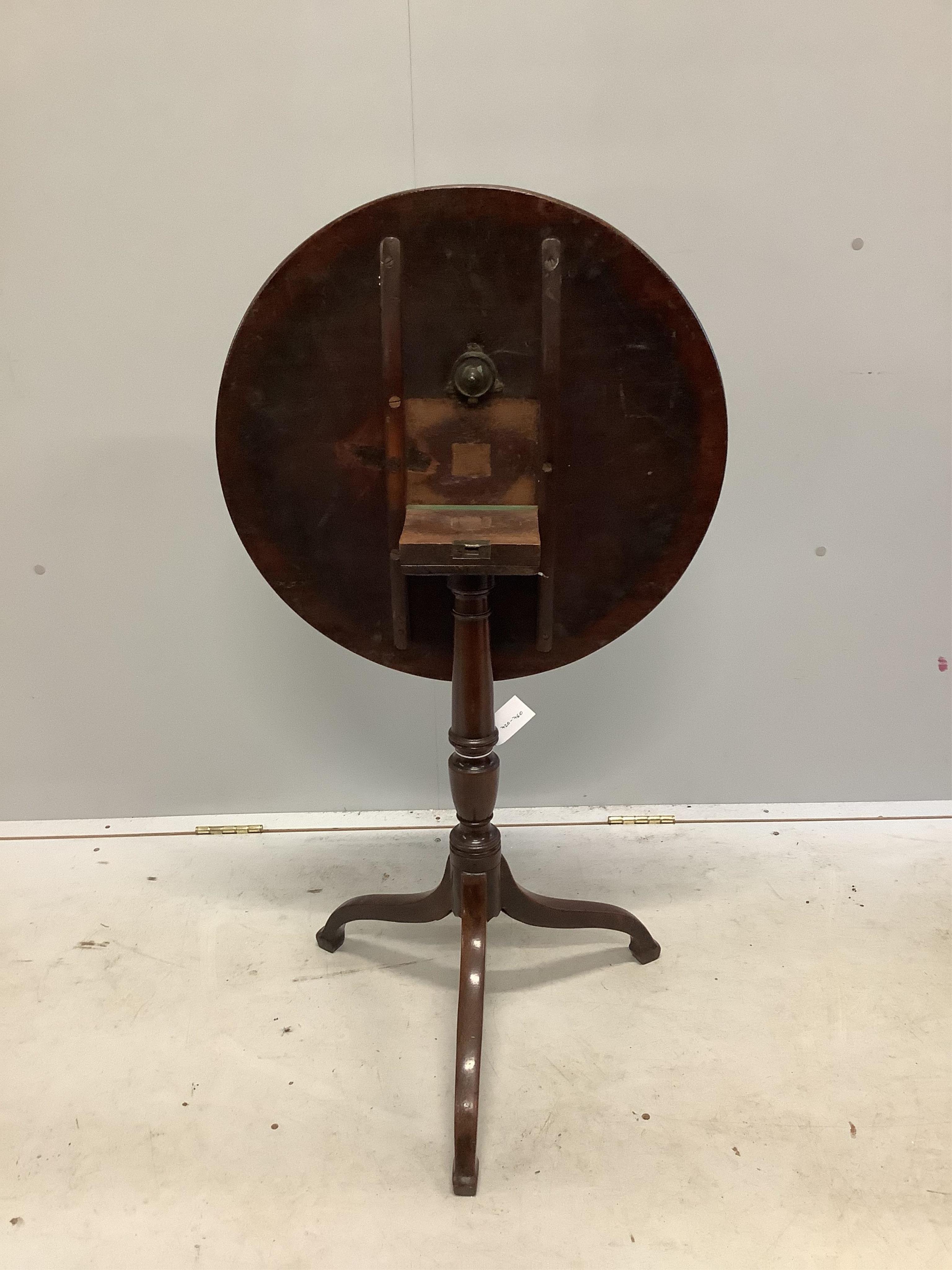 A George III circular mahogany tripod wine table, diameter 55cm, height 70cm. Condition - fair